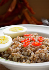 Buckwheat porridge with boiled egg and chili pepper