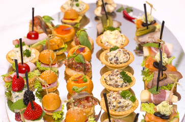 Canapes of cheese vegetables meat and seafood