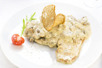 mushrooms in a cream sauce with steamed vegetables on a white background in the restaurant