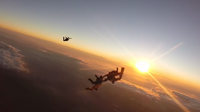 Skydiving team work sunset