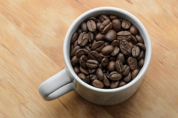 Roast organic coffee beans in white mug