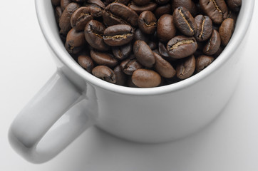Roast organic coffee beans in white mug