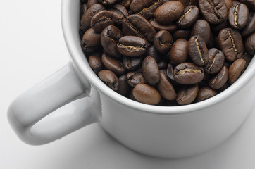 Roast organic coffee beans in white mug