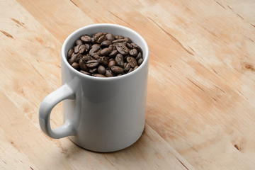 Roast organic coffee beans in white mug