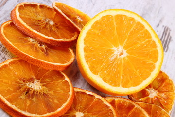 Dried and fresh orange on old wooden background