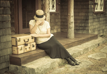 Distressed 1920s Girl Near Suitcases on Porch with Vintage Effec