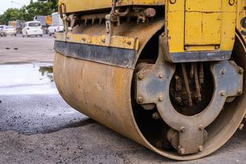 Fototapeta na wymiar Close up of heavy steamroller wheel at work site.