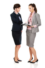 Two businesswomans discussing with eachother.