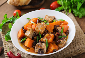 Baked spicy pumpkin with meat and beans
