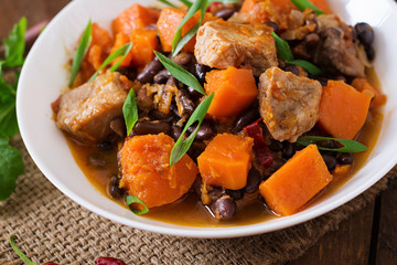 Baked spicy pumpkin with meat and beans