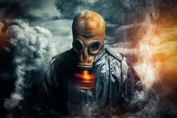 dramatic portrait of a man wearing a gas mask