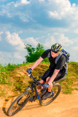 dynamic picture of a cyclist in motion on a mountain road