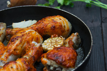 fried chicken drumsticks in a frying pan