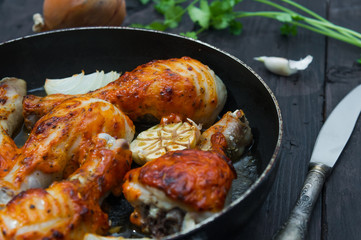 fried chicken drumsticks in a frying pan