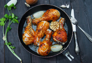 fried chicken drumsticks in a frying pan