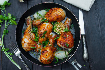 fried chicken drumsticks in a frying pan
