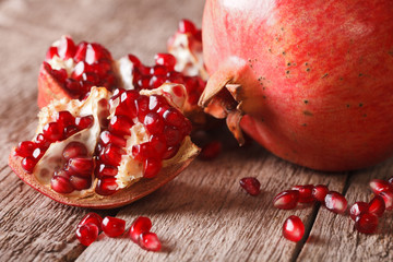 Ripe red pomegranate seeds macro on the table. vertical
