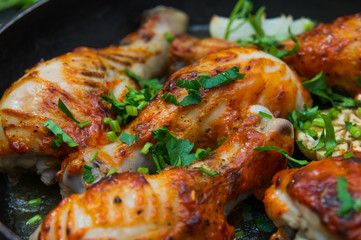 fried chicken drumsticks in a frying pan