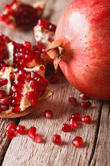 Ripe red pomegranate seeds macro on the table. vertical
