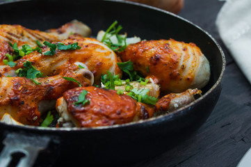 fried chicken drumsticks in a frying pan