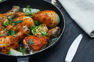 fried chicken drumsticks in a frying pan