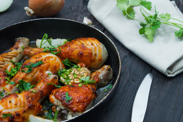 fried chicken drumsticks in a frying pan