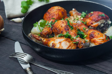fried chicken drumsticks in a frying pan