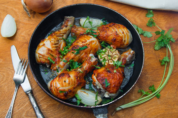 fried chicken drumsticks in a frying pan