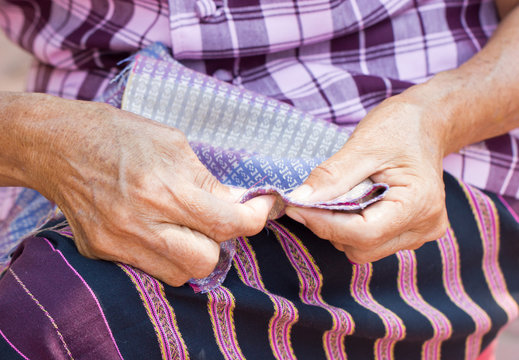 Asian Woman's Hand Sewing.