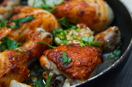 fried chicken drumsticks in a frying pan