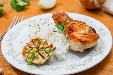 roasted chicken drumstick garnished with rice