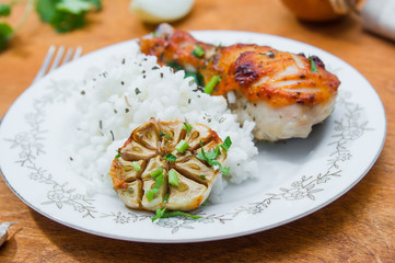 roasted chicken drumstick garnished with rice