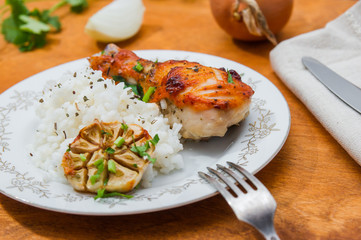 roasted chicken drumstick garnished with rice