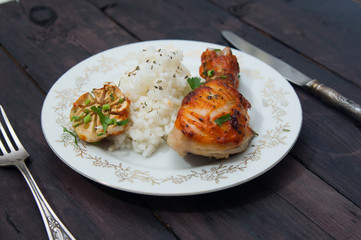 roasted chicken drumstick garnished with rice