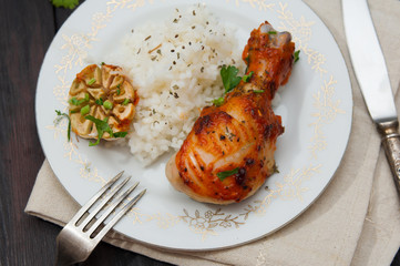 roasted chicken drumstick garnished with rice
