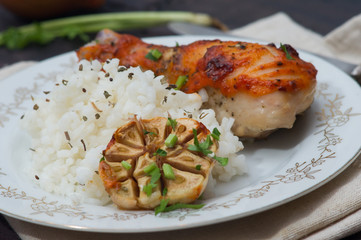 roasted chicken drumstick garnished with rice