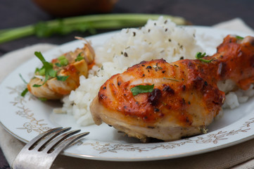 roasted chicken drumstick garnished with rice