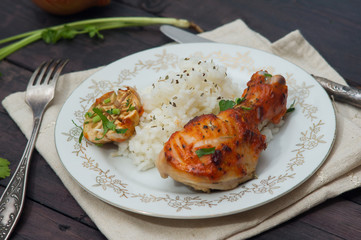roasted chicken drumstick garnished with rice