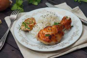 roasted chicken drumstick garnished with rice