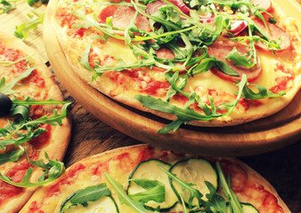 Pizza with sausage, cheese, ruccola, zucchini