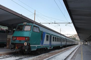 Fototapeta na wymiar Train and empty platform in station in Trieste,Italy