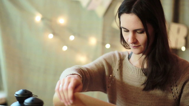 Young Woman Wrapping Christmas Gifts At Home