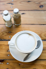 Hot art Latte Coffee in a cup on wooden table and Coffee shop bl