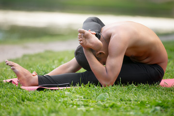 Yoga on mat on riverbank