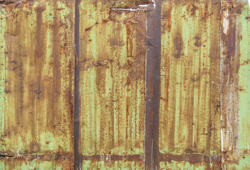 Fragment of a fence from a rusty metal sheets