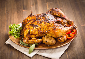 Grilled chicken on wooden plate