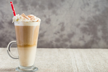 Latte coffee from left side of wooden table