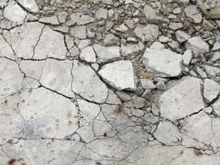Obraz premium A grungy fractured concrete pavement for textural background