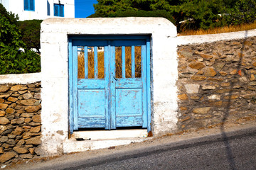 blue door in antique   santorini greece   white wall