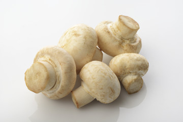 Button Mushrooms over white background.